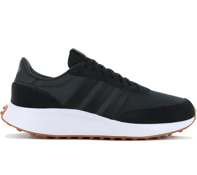 A side view of a black Adidas sneaker with a white sole and brown outsole.