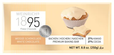 A bar of white chocolate with a cupcake and a star-shaped cookie, both frosted with white icing.