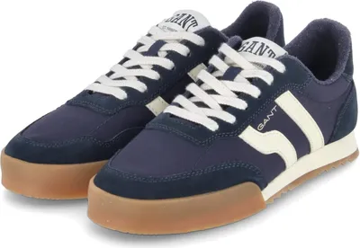 A pair of dark blue low-top sneakers with white laces and a gum sole.
