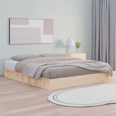 A bedroom scene with a bed, nightstand, lamp, and artwork.