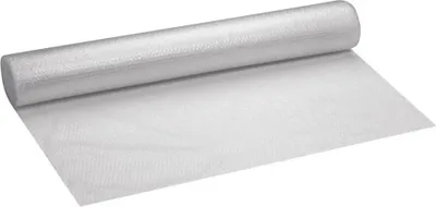 A roll of bubble wrap is laid out on a white surface.