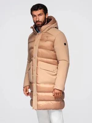 A man wearing a beige winter jacket.