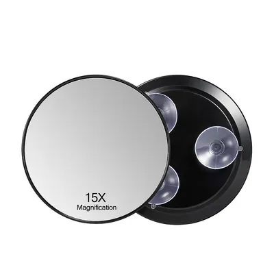 A round magnifying mirror with suction cups on a white background.