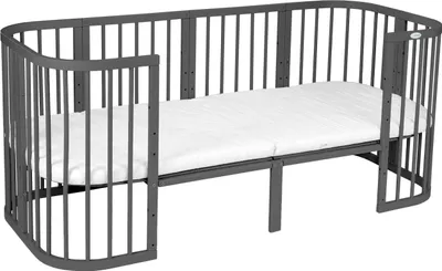 A gray crib with a white mattress is shown against a white background.