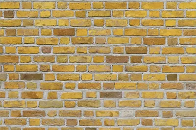 Produktbild von Wallario Premium Vliestapete Fototapete Ziegelsteinwand in gelb - Backsteine in der Größe 400 x 267 cm, extra dick, wird in 5 Teilen geliefert