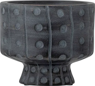 A close-up studio shot of a decorative ceramic pot.