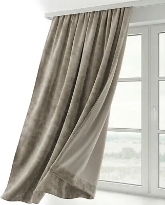 A taupe velvet curtain hangs in front of a window.
