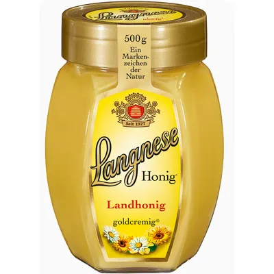 A jar of Langnese honey on a white background.