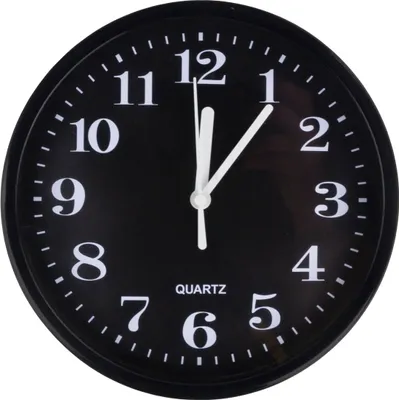 A black analog wall clock with white numbers and hands.