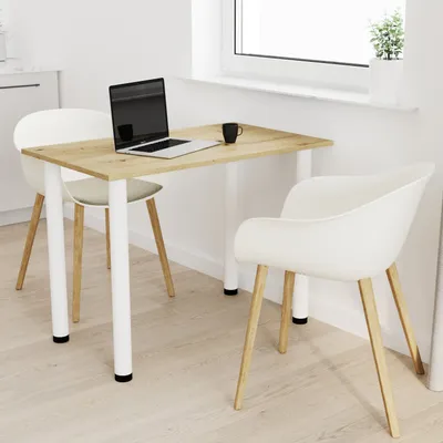 A dining table with two chairs in a bright, modern room with a window.