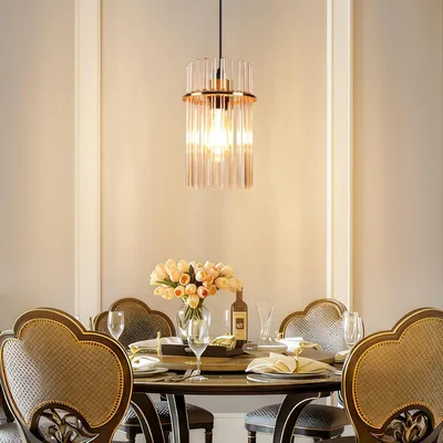 A dining table set with chairs and a chandelier hanging above.