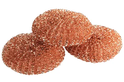 Three copper scouring pads are arranged in a cluster on a white background.
