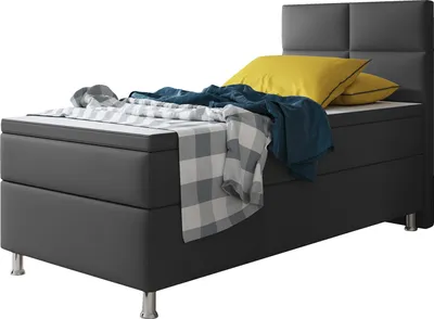 A close-up shot of a modern bed with a dark gray frame and a textured headboard.