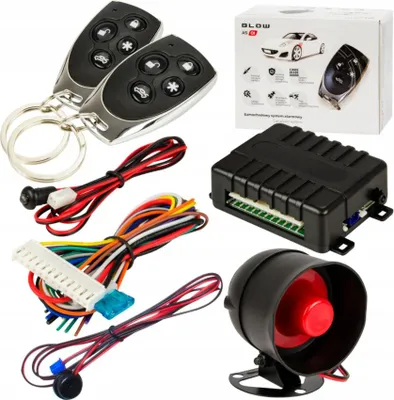 A collection of car alarm components including two key fobs, a central control unit, a siren, and various wiring harnesses, laid out on a white background.