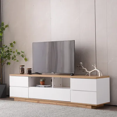A modern TV stand with a television on top, placed in a living room setting.
