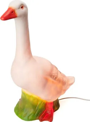 A white goose-shaped lamp with a red beak and orange accents on a green base, set against a white background.