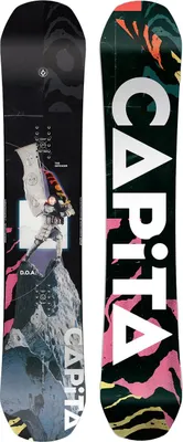 Two snowboards are shown side-by-side against a black background. The snowboard on the left has a dark, abstract graphic with text and an image of a person. The snowboard on the right has the brand name 'CAPITA' in large white letters against a colorful, a
