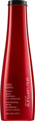 A red bottle of Shu Uemura shampoo against a white background.