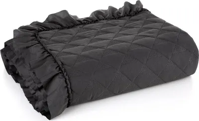 A folded black quilted blanket with ruffles on one side, shown at an angle on a white background.