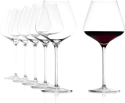 A set of wine glasses, with one glass filled with red wine.