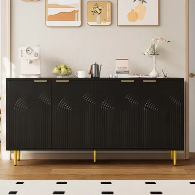 A black sideboard with gold handles and legs, decorated with arched patterns, is placed in a room with artwork on the wall and a rug on the floor.