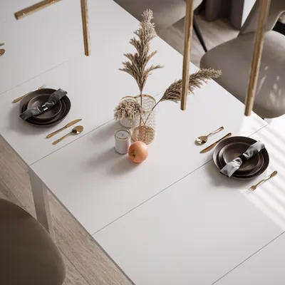 A dining table set for a meal with decorative elements.