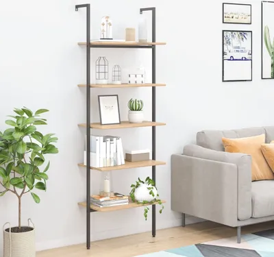 A ladder shelf unit with decorative items and books, placed next to a sofa.