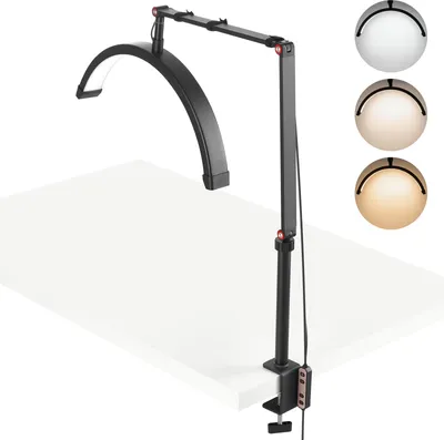 A black adjustable LED lamp with a curved light bar is clamped to a white desk. Three circular swatches showing different light colors are displayed to the right of the lamp.
