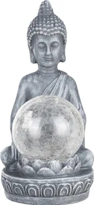 A gray Buddha statue holding a clear, cracked glass sphere, sitting on a lotus flower base.