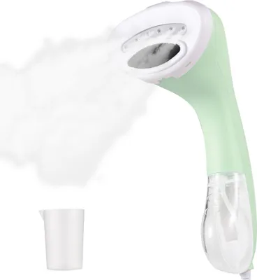 A portable garment steamer and a small measuring cup against a white background.