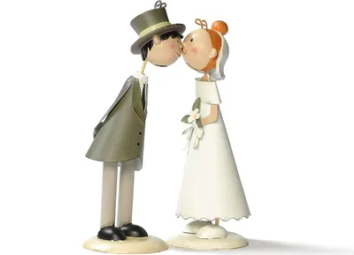 A wedding cake topper of a bride and groom kissing.