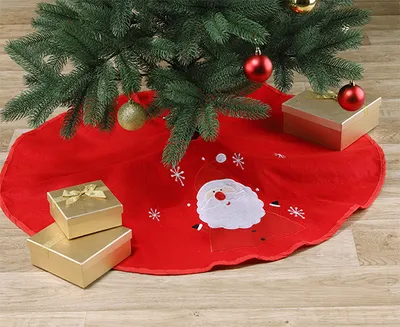 A Christmas tree skirt with Santa Claus and snowflakes, decorated with gift boxes and ornaments.