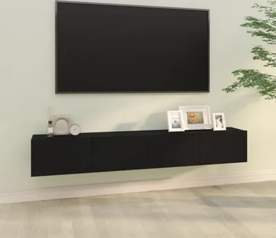 A black floating media console mounted on a light green wall, with a black television mounted above it.