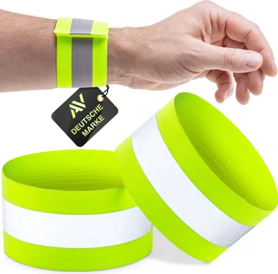 A person's wrist wearing a reflective armband, with two more armbands in the foreground.