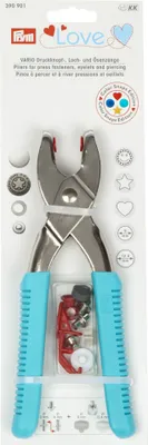 The image shows the packaging of a Prym Love Vario-Zange tool kit, which includes pliers and various accessories for attaching press fasteners, eyelets, and piercing.