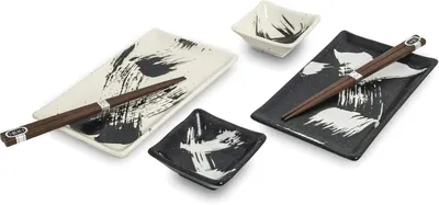 A set of sushi plates and chopsticks arranged on a white background.