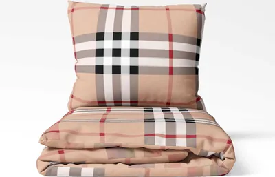 A folded duvet and a pillow with a plaid pattern.