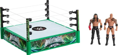 A WWE wrestling ring playset with two action figures, The Rock and Roman Reigns.