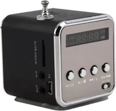 A close-up, angled view of a small, cube-shaped portable radio with a digital display and buttons.