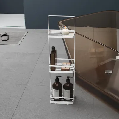 A white metal shelf unit with bathroom products next to a bathtub.