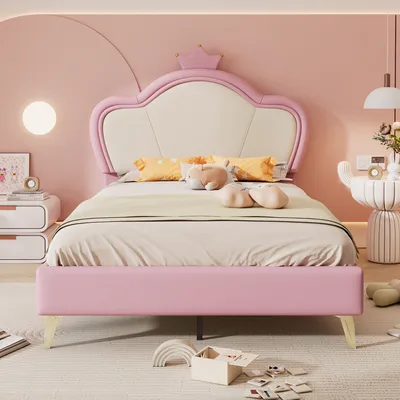 A pink bed with a crown-shaped headboard in a child's bedroom.