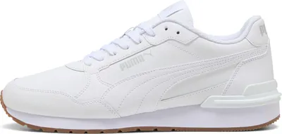 A white Puma sneaker with a brown sole is shown against a white background.