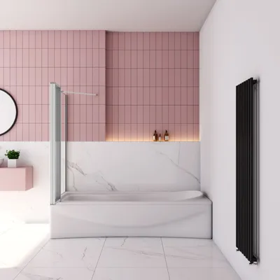 A modern bathroom with a bathtub and shower screen.