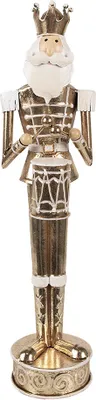 A gold-colored nutcracker with a drum and a crown.