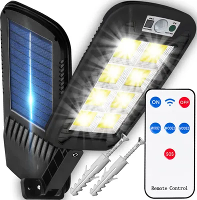 A solar-powered outdoor light with a remote control and mounting hardware.