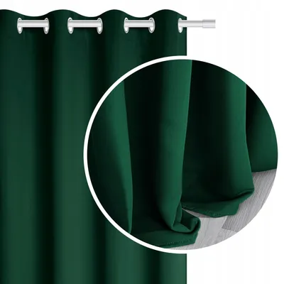 A close-up of a dark green curtain with grommets, showing the texture and drape of the fabric.