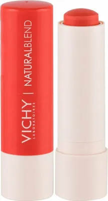 A close-up studio shot of a coral lipstick and its red casing.