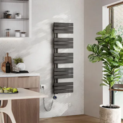 A modern kitchen or bathroom setting with a towel warmer, cabinets, and a plant.
