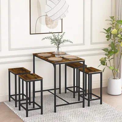 A dining set with a tall table and four stools in a room setting.