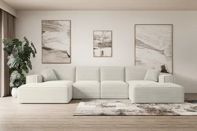A modern living room with a large U-shaped sectional sofa, abstract art on the wall, and a large potted plant.